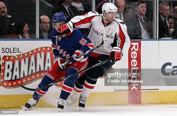 Eric Fehr of the Washington Capitals skates against Enver Lisin of the New York Rangers on February 4, 2010 at Madison Square Garden in New York City.