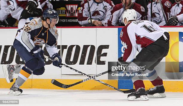 Ryan Jones of the Nashville Predators skates against John-Michael Liles of the Colorado Avalanche on February 4, 2010 at the Sommet Center in...