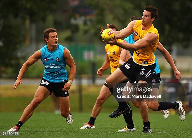 Luke Ball of the Magpies looks to pressure Darren Jolly of the Magpies as he gathers the ball during a Collingwood Magpies intra-club AFL match at...