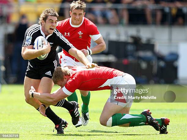 Kurt Baker of New Zealand is tackled by Chris Davies of Wales in the match between New Zealand and Wales during day one of the Wellington IRB Sevens...