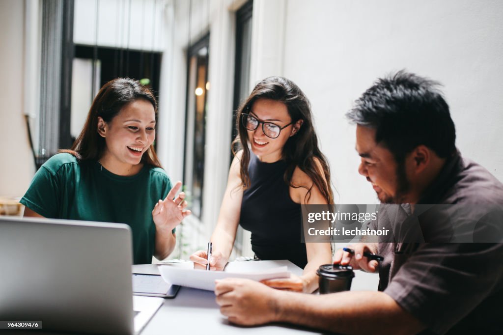 Young people working until late in the office, finishing up with work