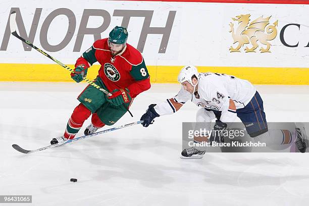 Fernando Pisani of the Edmonton Oilers attempts to knock the puck away from the Brent Burns of the Minnesota Wild during the game at the Xcel Energy...