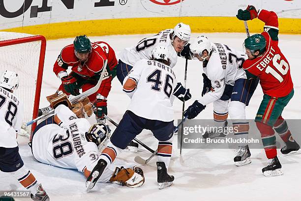 Robbie Earl and Andrew Ebbett of the Minnesota Wild battle with Jeff Deslauriers, Alex Plante, Zack Stortini, and Denis Grebeshkov of the Edmonton...