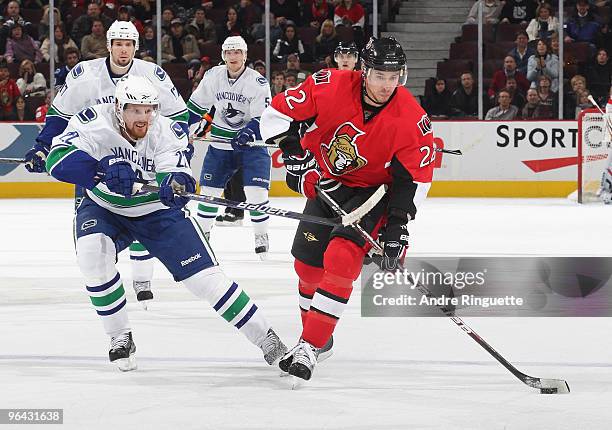 Daniel Sedin of the Vancouver Canucks reaches with his stick to stop a shot by Chris Kelly of the Ottawa Senators at Scotiabank Place on February 4,...