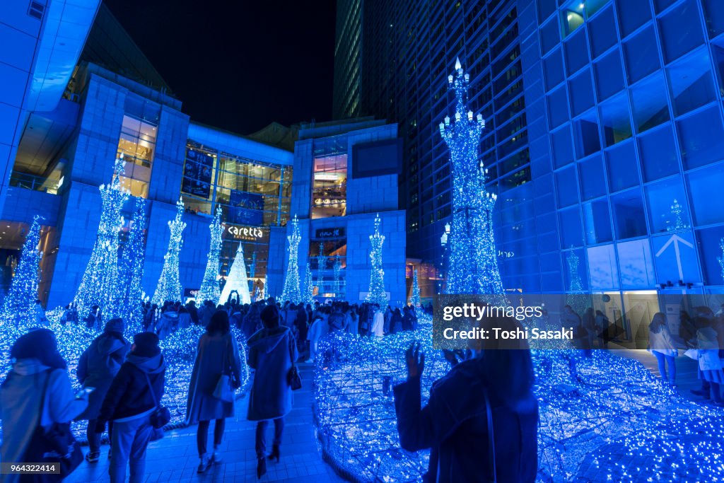 People enjoying to watching and photographing the Caretta Illumination Show, which is illuminated by approximately 250,000 LED lights every 20 minutes in Caretta Shopping Mall Shiodome Tokyo Japan on December 26 2017.