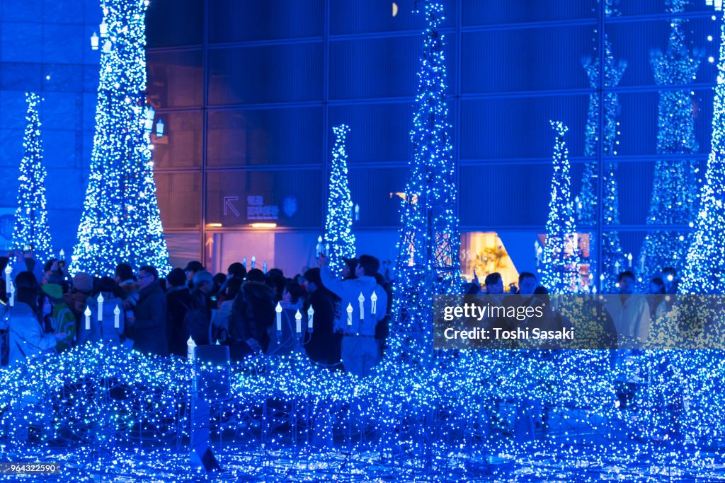 People enjoying to watching and photographing the Caretta Illumination Show, which is illuminated by approximately 250,000 LED lights every 20 minutes in Caretta Shopping Mall Shiodome Tokyo Japan on December 26 2017.