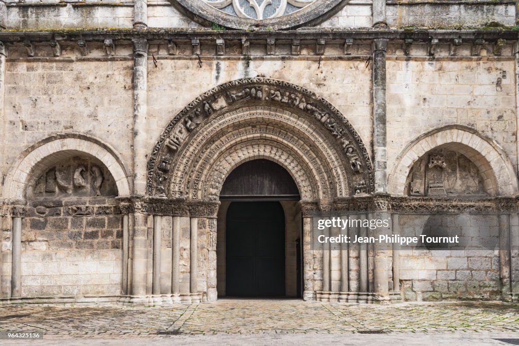 Entrance door with voussoirs in Saint Léger Church, Cognac, France