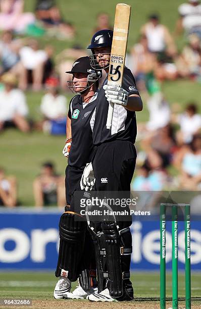 Jacob Oram of New Zealand celebrates after scoring fifty runs with Neil Broom of New Zealand during the first one day international match between the...
