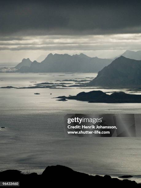 ocean and mountains in backlight - austvagoy stock pictures, royalty-free photos & images