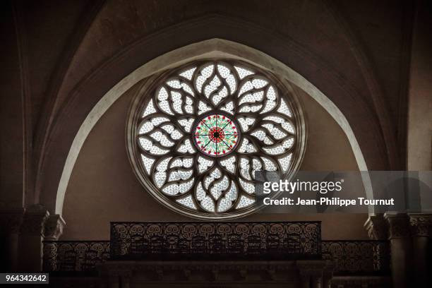 rose window in saint léger church (eglise saint-léger), in cognac, france - stained glass church stock pictures, royalty-free photos & images