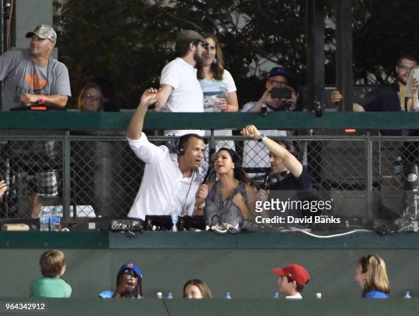 Announcers Alex Rodriguez, Jessica Mendoza and Matt Vasgersian sing " Take me out to the ballgame" during the seventh inning stretch in a game...