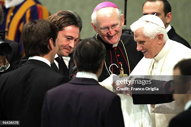 Manuele Malenotti and Michele Malenotti , vice presidents of clothing company Belstaff, give a white jacket as a gift to Pope Benedict XVI during the...