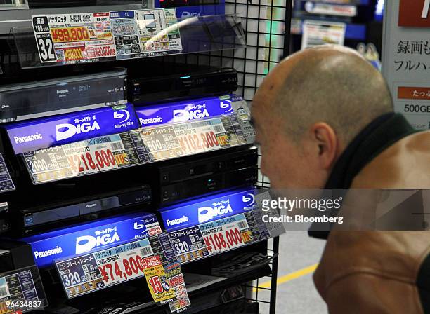 Customer looks at Panasonic Corp. "Diga" blu-ray disc recorders at an electronics store in Tokyo, Japan, on Thursday, Feb. 4, 2010. Panasonic Corp.,...