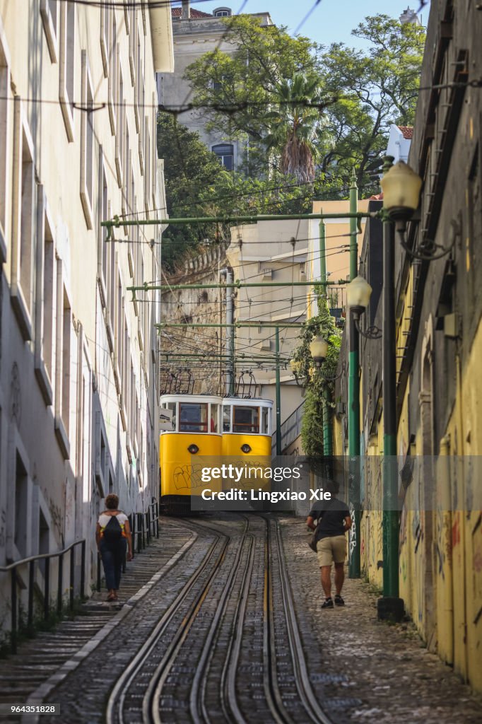 Travelers walking along Funicular Elevador Do Lavra in Baixa District, Lisbon, Portugal