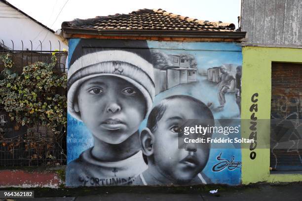 Mural painting and graffitis in the La Victoria area of Santiago de Chile. In 50 years, its inhabitants built an alternate city, resisted to dictator...