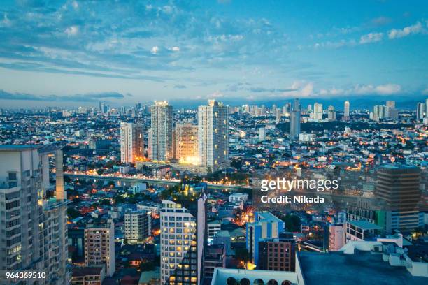 aerial view at twilight of makati business district, manila, philippines - philippines stock pictures, royalty-free photos & images