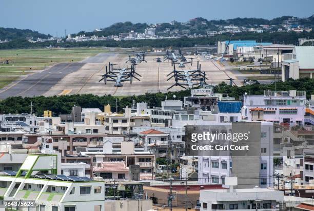 Osprey aircraft sit on a runway at Marine Corps Air Station Futenma on May 31, 2018 near Naha, Okinawa prefecture, Japan. Demonstrators protesting...