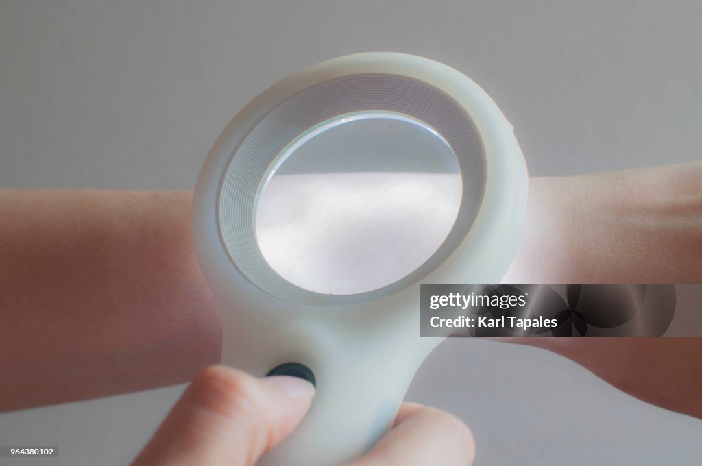 Using a magnifying lens for skin