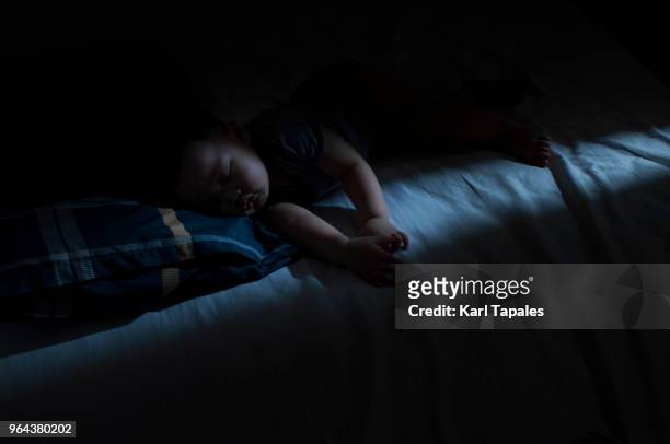 a baby boy is sleeping at night - nursery night stock pictures, royalty-free photos & images