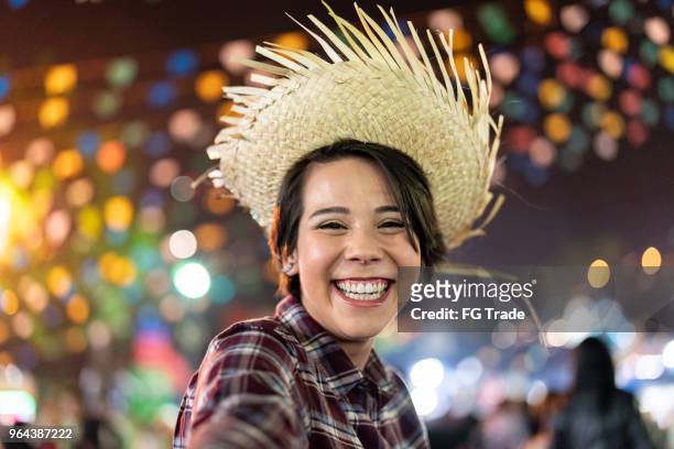 young woman enjoying a great time in the famous brazilian junina party (festa junina) - caipira style - hispanic month stock pictures, royalty-free photos & images