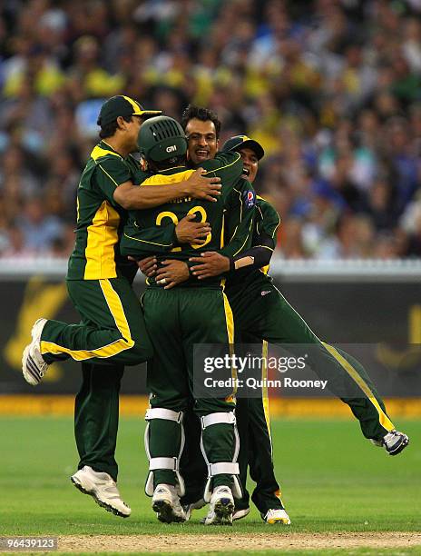 Shoaib Malik of Pakistan is congratulated by team-mates after getting a wicket during the Twenty20 international match between Australia and Pakistan...