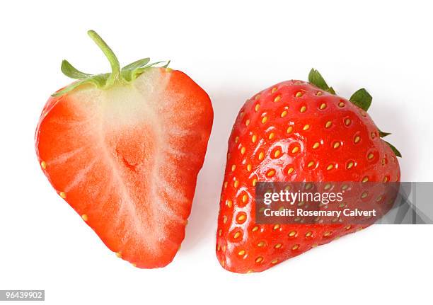 one fresh strawberry cut in half. - fatia - fotografias e filmes do acervo