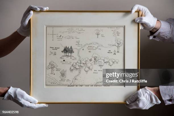 Sotheby's art handlers hold 'The Original Map of the Hundred Acre Wood' by E.H. Shepard, estimated at £100,000 to £150 at the unveiling of original...