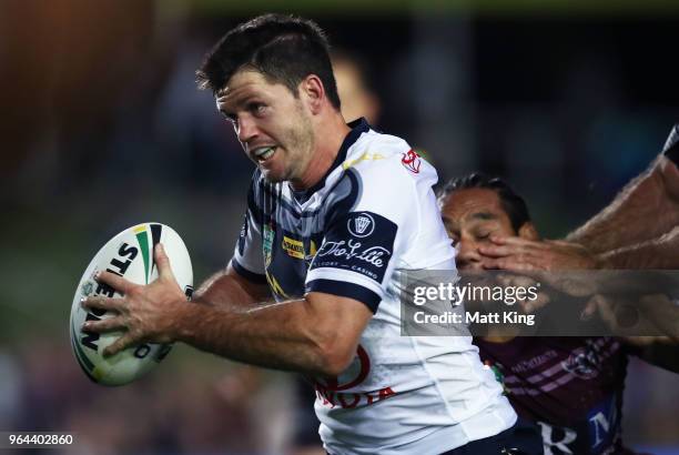 Lachlan Coote of the Cowboys takes on the defence during the round 13 NRL match between the Manly Sea Eagles and the North Queensland Cowboys at...