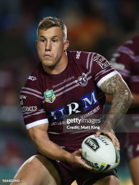 Trent Hodkinson of the Sea Eagles passes during the round 13 NRL match between the Manly Sea Eagles and the North Queensland Cowboys at Lottoland on...
