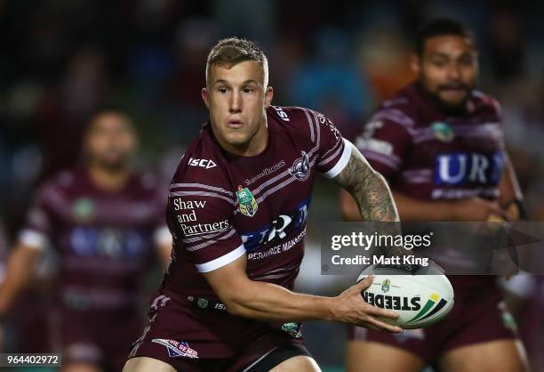 Trent Hodkinson of the Sea Eagles passes during the round 13 NRL match between the Manly Sea Eagles and the North Queensland Cowboys at Lottoland on...