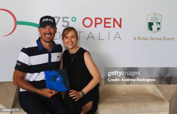 Gregory Havret of France poses with an award for competing in his 500th event alongside wife Aude during day one of the Italian Open at Gardagolf CC...