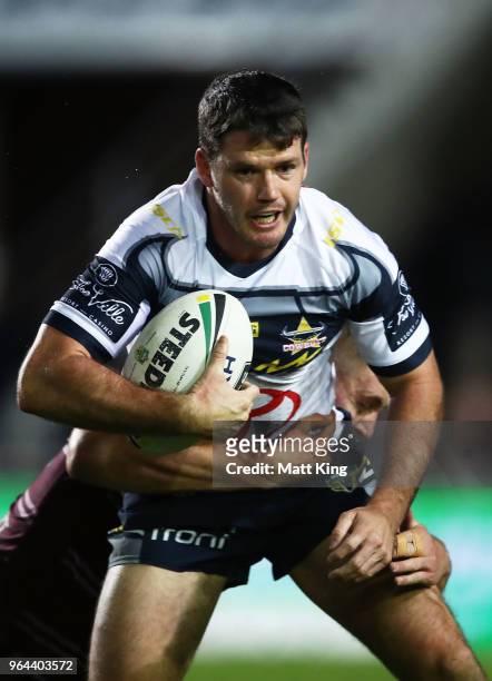 Lachlan Coote of the Cowboys is tackled during the round 13 NRL match between the Manly Sea Eagles and the North Queensland Cowboys at Lottoland on...