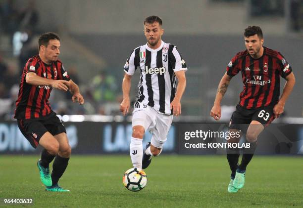 Juventus' midfielder from Bosnia and Herzegovina Miralem Pjanic controls the ball next to Milan's Italian forward Patrick Cutrone and Milan's Italian...