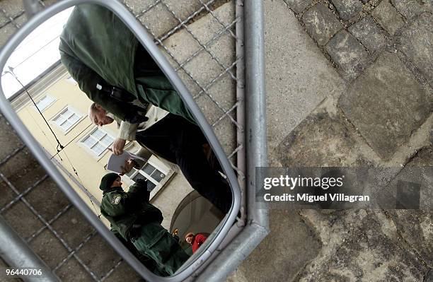 German police officer checks documents of a men entering a police zone prior to the 46th Munich Security Conference next to the Bayerischer Hof hotel...