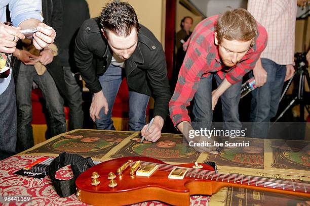 Maroon 5, Adam Gardner, and Stefan Lessard sign posters for charity at the Green Music Group Celebrates It's Official Launch Party at Jane House on...