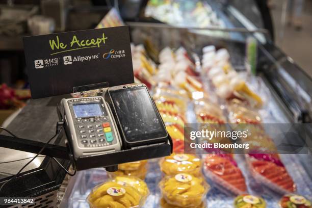 Signage for digital payment services Ant Financial's Alipay, an affiliate of Alibaba Group Holding Ltd., and Octopus Holdings Ltd. Are displayed next...