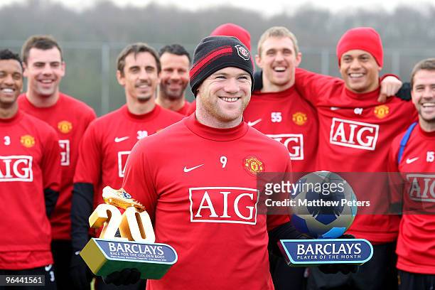 Wayne Rooney of Manchester United poses with the Barclays Golden Boot Award and Barclays Player of the Month Award for Janurary at Carrington...