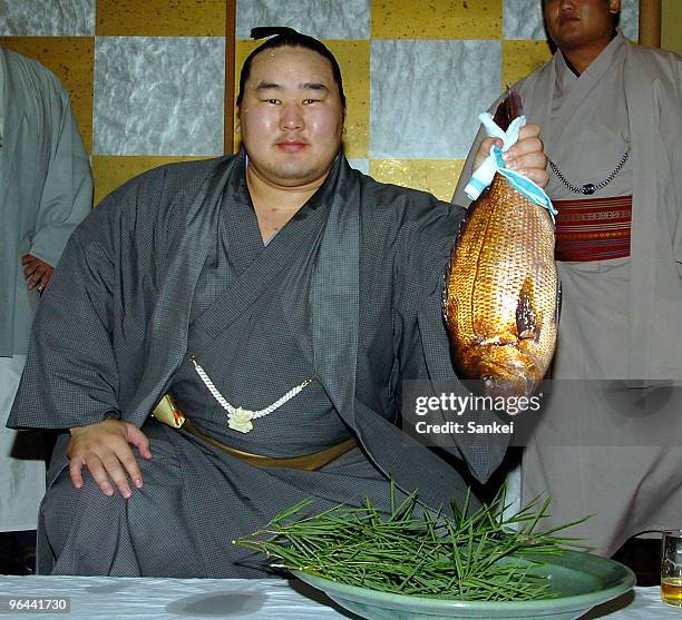 Asashoryu poses for photographs after winning the Grand Sumo Autumn Tournament at Takasago stable on September 23, 2006 in Tokyo, Japan.