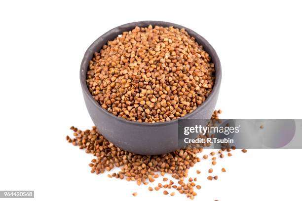 buckwheat groats in a bowl, close up photo - buckwheat isolated stock pictures, royalty-free photos & images