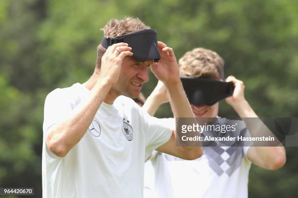 Thomas Mueller and Matthias Ginter attend a Blind Football demonstration match with national players of the German national Blind Football team at...