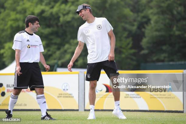 Thomas Mueller smiles during a Blind Football demonstration match with national players of the German national Blind Football team at Sportanlage...