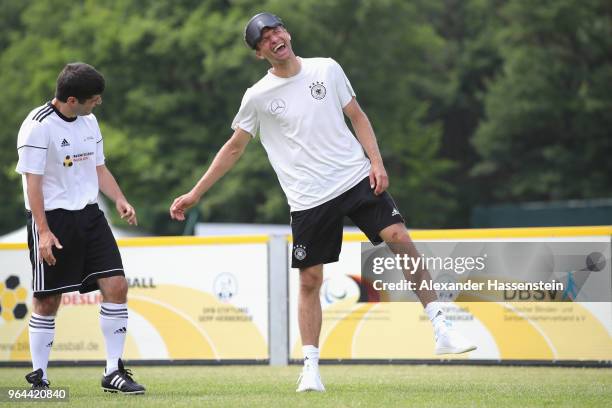 Thomas Mueller smiles during a Blind Football demonstration match with national players of the German national Blind Football team at Sportanlage...