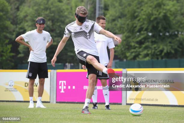 Matthias Ginter plays the ball during a Blind Football demonstration match with national players of the German national Blind Football team at...