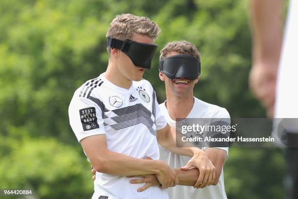 Thomas Mueller and Matthias Ginter attend a Blind Football demonstration match with national players of the German national Blind Football team at...