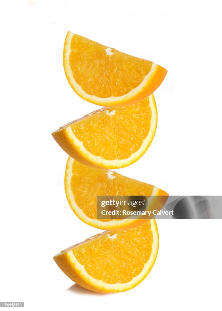 Stack of orange segments, white background.