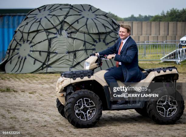 Dutch King Willem-Alexander drives a quad during a working visit at the Fieldlab Smartbase of the Commando Land Armed Forces in Soesterberg, The...