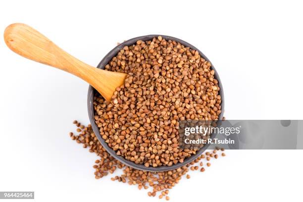 buckwheat groats in a bowl, close up photo - buckwheat isolated stock pictures, royalty-free photos & images
