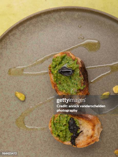 grilled baguette with pistachio pesto and black garlic. - extra virgin olive oil stock pictures, royalty-free photos & images
