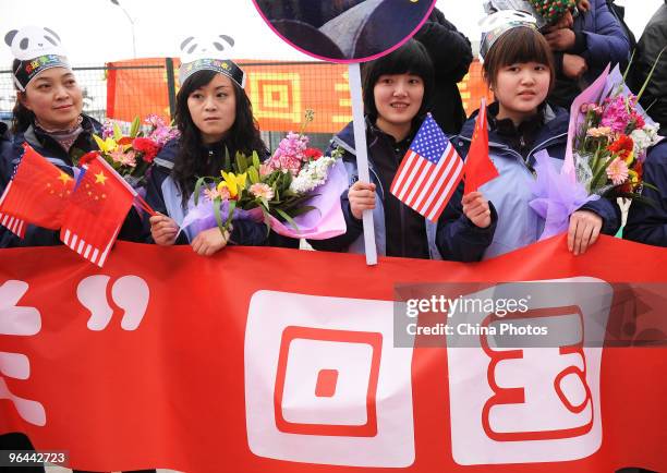 Panda fans welcome American-born giant pandas Tai Shan and Mei Lan with a banner reading 'returning to homeland' at the Chengdu Shuangliu...