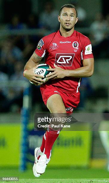Quade Cooper of the Reds makes a break during the Super 14 trial match between the Western Force and the Reds at ME Stadium on February 5, 2010 in...